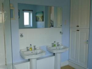 a bathroom with two sinks and a mirror at Cherry End Bed and Breakfast in Chichester