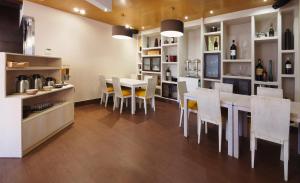 a kitchen and dining room with a table and chairs at Hotel Apartamentos Dabarca in Pontevedra