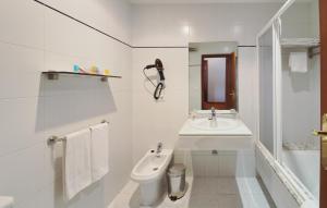 a white bathroom with a sink and a toilet at Hotel Apartamentos Dabarca in Pontevedra +12 photos
