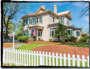 a white picket fence in front of a house at Charles Bass House Bed & Breakfast in South Boston +9 photos