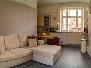 a living room with a couch and a kitchen at Church Lane Apartments in Boston