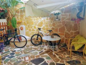 two bikes parked in a room with a stone wall at Athens Glyfada Studio in Athens