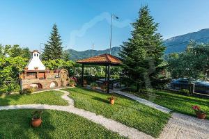 a garden with a gazebo and a pathway at Pantelidis Rooms in Skala Potamias +12 photos