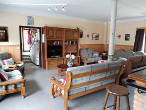 a living room with a couch and a tv at Sneeuweifel in Burg-Reuland