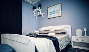 a bedroom with a white bed and a white chair at Eco-friendly Estate I in Primošten