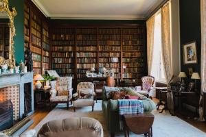 a living room filled with lots of books at Clonalis House - Guesthouse in Castlerea