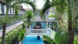 an aerial view of a resort with palm trees and a pool at Raintree Boutique Villa & Gallery in Yogyakarta