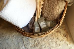 a basket with three candles in it on a floor at Arya Nobile Dimora in Carovigno