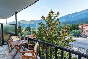 balcón con mesa y sillas y vistas a las montañas en Pantelidis Rooms, en Skala Potamias