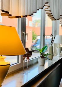 a yellow lamp sitting on a counter next to a window at Parkhotel Pretzsch in Bad Schmiedeberg