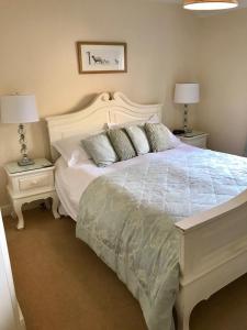 a bedroom with a large white bed with two night stands at Cocketts Hotel in Hawes