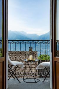 a table and chairs on a balcony with a view at Hotel San Bernardo in Contra