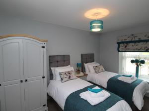 a bedroom with two beds with towels on them at Colliery Cottage in Durham