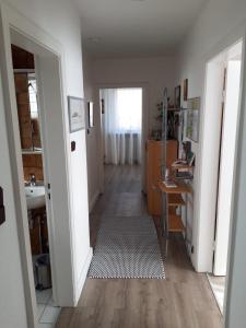 a hallway of a home with a desk and a sink at Ferienwohnung Hummer im Haus Daheim in Helgoland