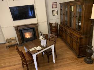 a living room with a table and a fireplace at The Corner House Hotel in Annan