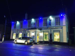 a car parked in front of a building at night at The Cornubia Inn in Hayle
