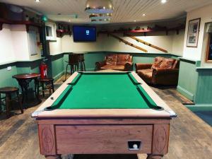 a room with a pool table in a bar at The Cornubia Inn in Hayle