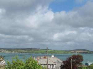 a view of a large body of water with a house at Coswarth House in Padstow