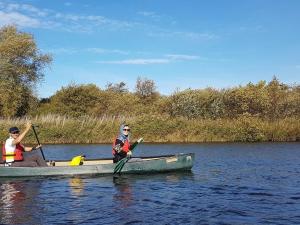 two people in a canoe on a lake at Cotenham Barn in South Walsham