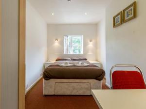 A bed or beds in a room at The Cotswold