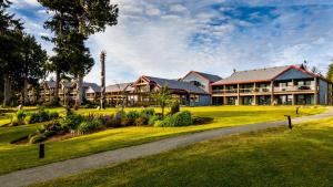 a large house with a green yard with a driveway at Best Western Plus Tin Wis Resort in Tofino