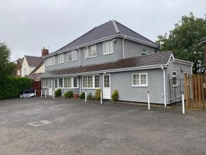 a large gray house with a lot of windows at Cranmore Guest House in Birmingham