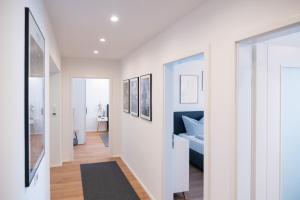 a hallway with white walls and a bed in a room at MH Living - 5 - Scandinavian Living Dream in Center in Graz