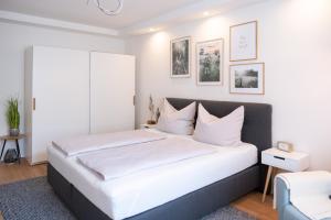 a white bedroom with a large bed with white pillows at MH Living - 5 - Scandinavian Living Dream in Center in Graz