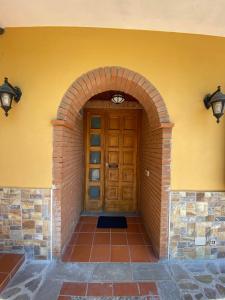 an entrance to a building with a wooden door at B & B Il Campanile in Perdifumo