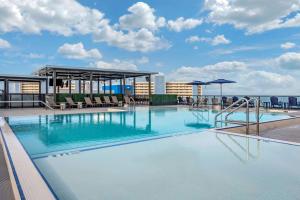 a large swimming pool on the roof of a building at Cambria Hotel St Petersburg-Madeira Beach Marina in St. Pete Beach