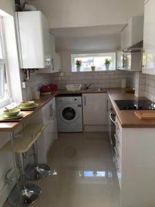 a kitchen with a sink and a washing machine at Townhouse @ 97 Edleston Road Crewe in Crewe