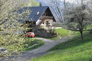 a house with a car parked in front of it at La Grange Aux Loups in Queige