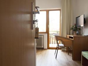 a door to a room with a desk and a deskablish at Landhotel Graf in Schliengen