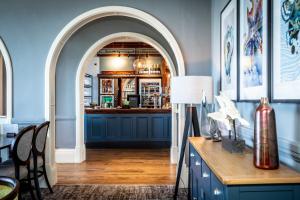 an archway leading into a bar with a wooden table at The Marine in Whitstable