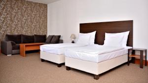 Voodi või voodid majutusasutuse Hotel Atrium toas