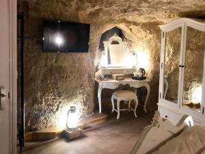 a bathroom with a sink and a mirror in a cave at The Grotto in South Shields