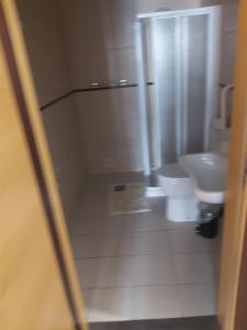 a bathroom with a toilet and a sink at Areia Da Foz in Figueira da Foz