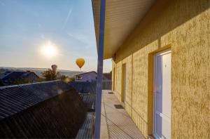 a view from the balcony of a house with a balloon in the sky at Domashniy in Kamianets-Podilskyi