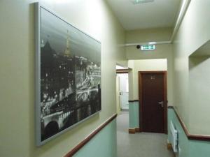 a hallway with a large picture of a city on the wall at Budget Hayat express hotel in Durham