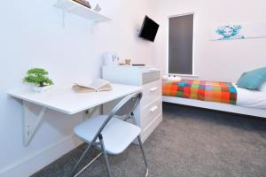 a bedroom with a desk and a bed and a desk at Townhouse @ Henry Street Crewe in Crewe