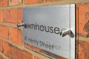 a sign on the side of a brick wall at Townhouse @ Henry Street Crewe in Crewe
