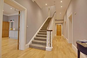 a hallway with a staircase in a home at Highfield Bed & Breakfast in Lymington