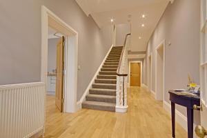a hallway with a staircase in a house at Highfield Bed & Breakfast in Lymington