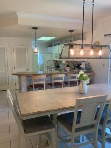 a kitchen with a large wooden table and chairs at Bahama Breeze #2 Sea Dancer Condos in South Padre Island