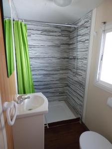 a bathroom with a shower and a sink at Camping Barraquetes in Sueca