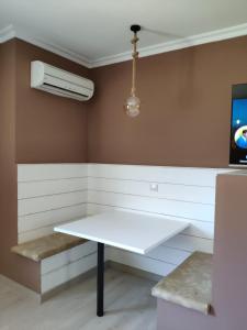 a room with a white table and a fan at Motel Caldas in Caldas de Reis