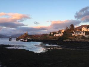 a body of water with houses and boats in it at Hillside in Kyleakin