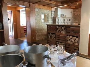 a kitchen with two pots and glasses on a table at Hotel Hohe Schule in Bad Überkingen