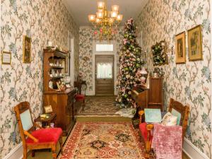 a living room with a christmas tree in the corner at Holly House of Hamilton in Hamilton