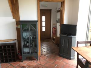 a living room with a fireplace and a tv at Horizon Barn in Market Rasen